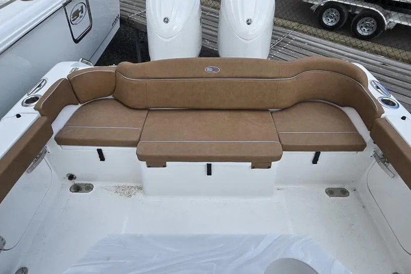 Slide: The Image of 2026 Sea Hunt Ultra 265 SE boat with tan cushioned seating area. - 14