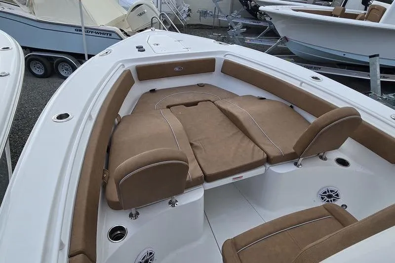 Slide: The Image of 2026 Sea Hunt Ultra 265 SE boat interior with tan seating and spacious layout. - 16