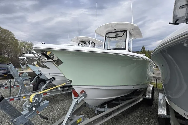 Slide: The Image of 2026 Sea Hunt Ultra 265 SE boat on trailer, displayed outdoors under cloudy sky. - 3