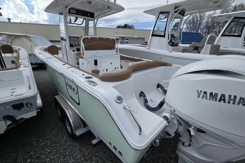 Slide: The Image of 2026 Sea Hunt Ultra 265 SE boat with Yamaha engine, displayed outdoors. - 8