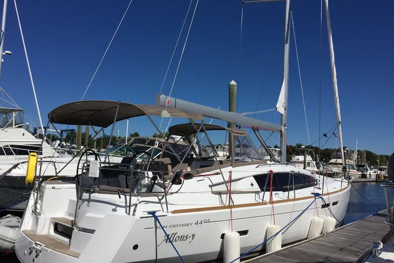 The Image of 2016 Jeanneau Sun Odyssey 44 DS sailboat docked at marina under clear blue sky. - 0