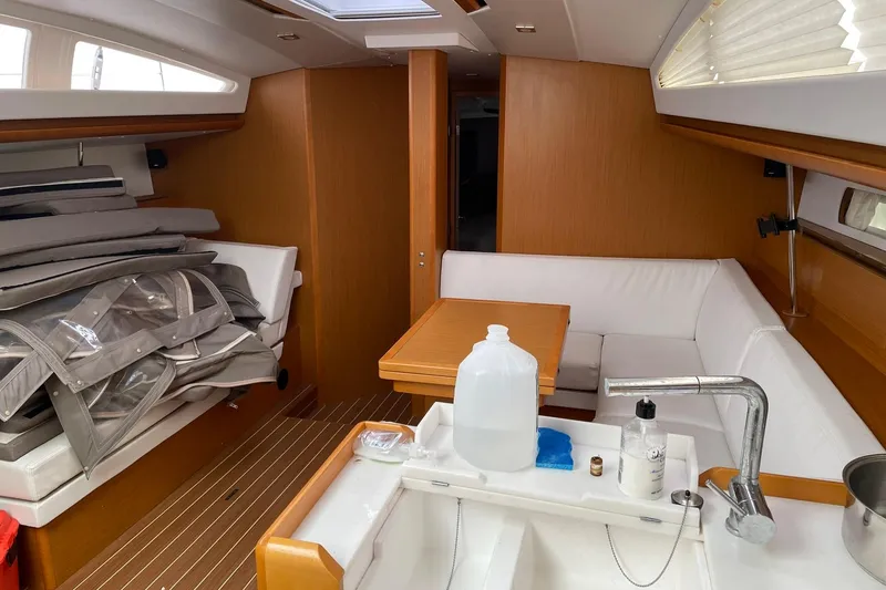 Slide: The Image of Interior of 2016 Jeanneau Sun Odyssey 44 DS sailboat with seating and kitchen area. - 10