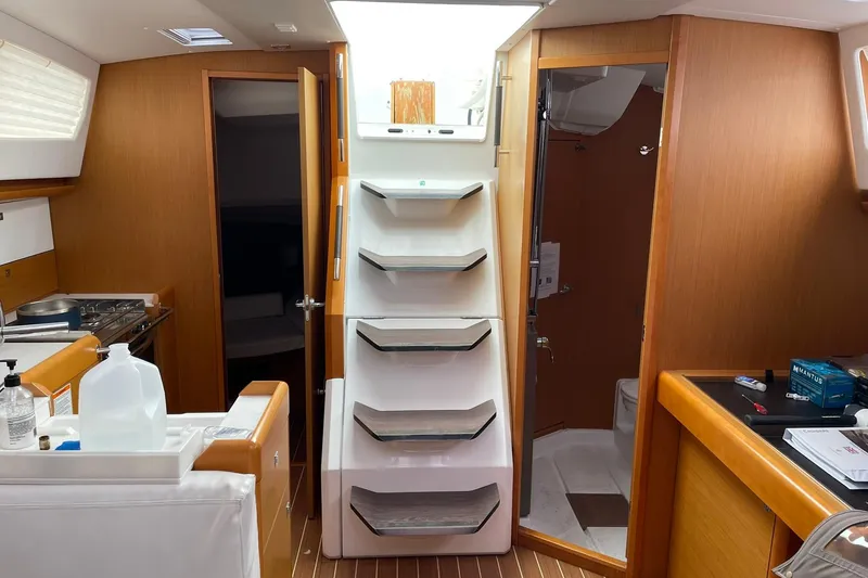 Slide: The Image of Interior of 2016 Jeanneau Sun Odyssey 44 DS yacht, featuring kitchen and stairs. - 12