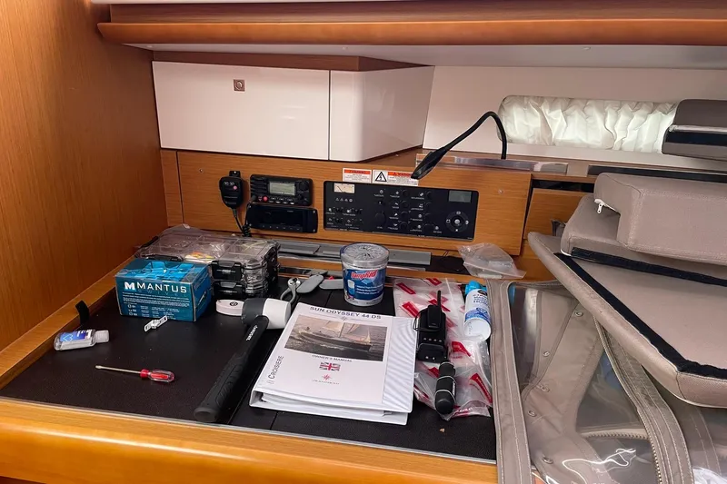 Slide: The Image of Interior of 2016 Jeanneau Sun Odyssey 44 DS with navigation equipment and manuals. - 15