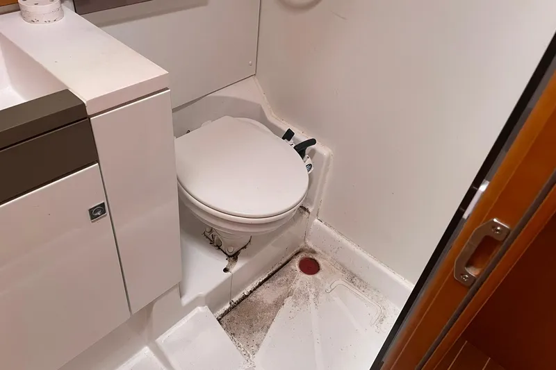 Slide: The Image of Bathroom interior of 2016 Jeanneau Sun Odyssey 44 DS yacht, featuring a compact toilet. - 19