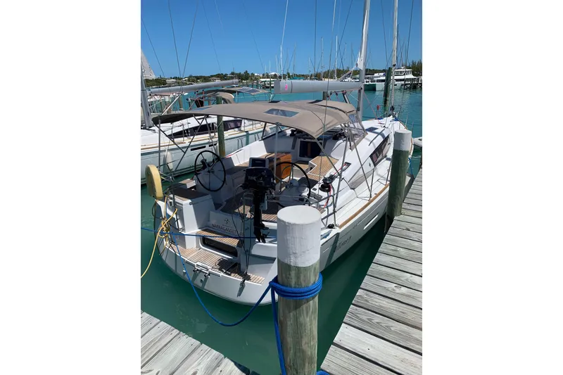 Slide: The Image of 2016 Jeanneau Sun Odyssey 44 DS docked at marina, featuring sleek design and spacious cockpit. - 2