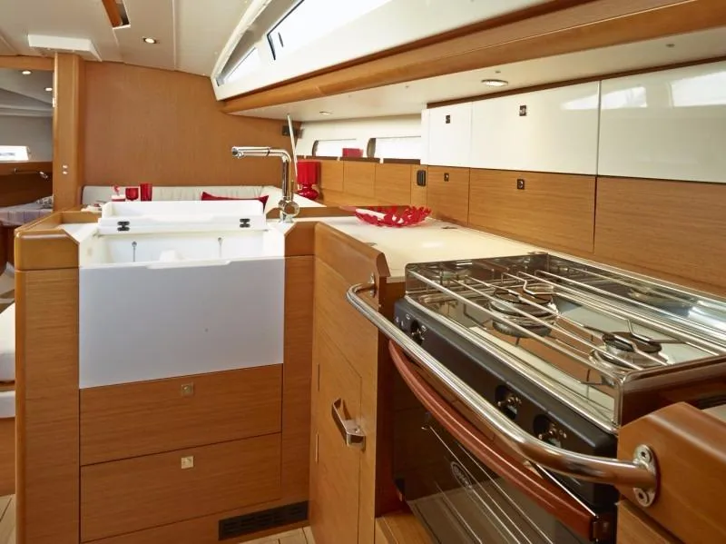 Slide: The Image of Manufacturer Provided Image: Modern kitchen area in 2016 Jeanneau Sun Odyssey 44 DS sailboat with stove and sink. - 6
