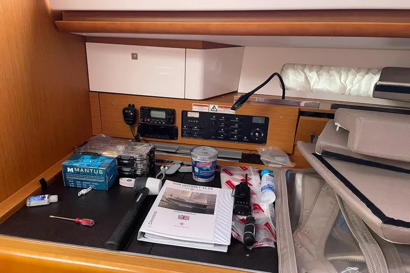 Slide: The Image of Navigation station on 2016 Jeanneau Sun Odyssey 44 DS with manuals and tools. - 9