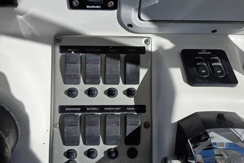 Slide: The Image of Control panel of a 2005 Everglades 223 Center Console boat with switches and buttons. - 10