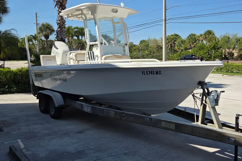 Slide: The Image of 2005 Everglades 223 Center Console boat on trailer, parked outdoors. - 4