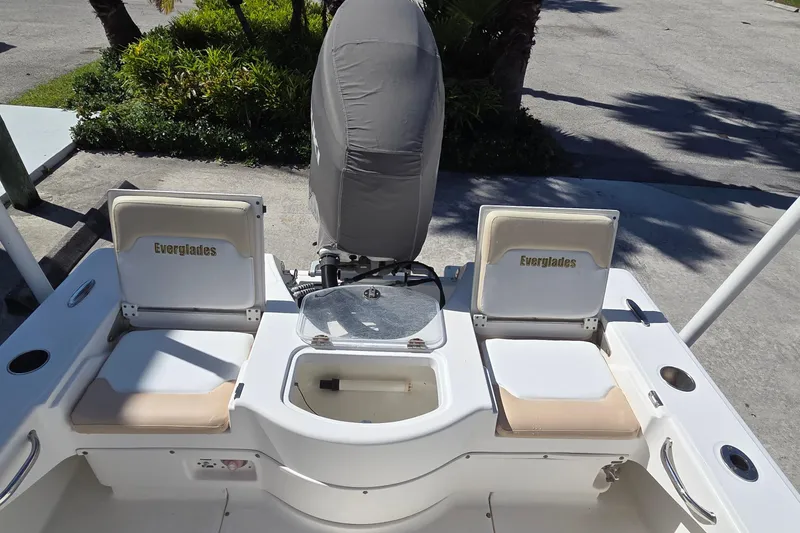 Slide: The Image of 2005 Everglades 223 Center Console boat interior with seating and storage compartments. - 6