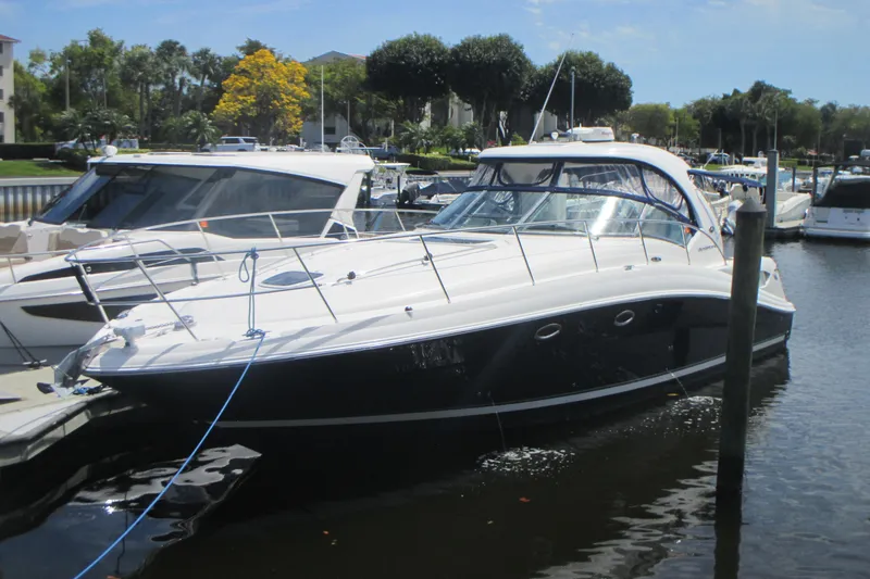 The Image of 2005 Sea Ray 390 Sundancer yacht docked in a marina under clear skies. - 0