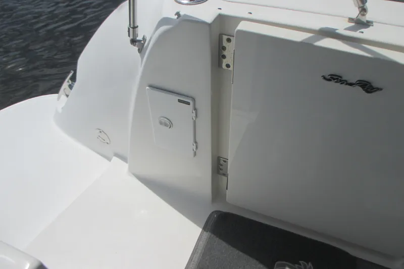 Slide: The Image of 2005 Sea Ray 390 Sundancer boat deck with storage compartment and logo. - 11