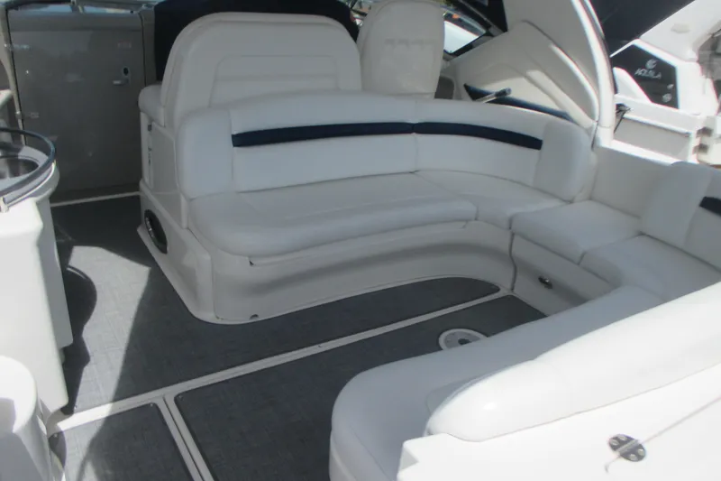 Slide: The Image of Luxurious interior of 2005 Sea Ray 390 Sundancer with white seating and modern design. - 12