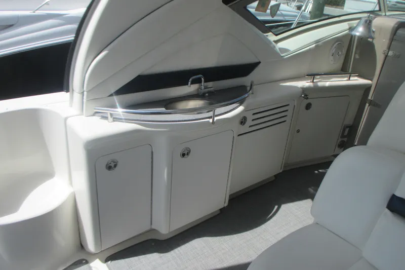 Slide: The Image of 2005 Sea Ray 390 Sundancer yacht interior with sink and storage cabinets. - 14