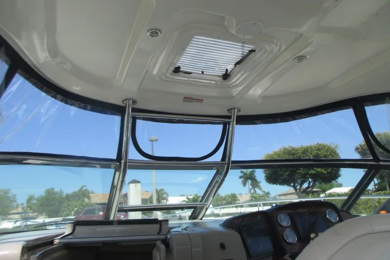 Slide: The Image of Interior view of 2005 Sea Ray 390 Sundancer boat cockpit with clear windows and control panel. - 17