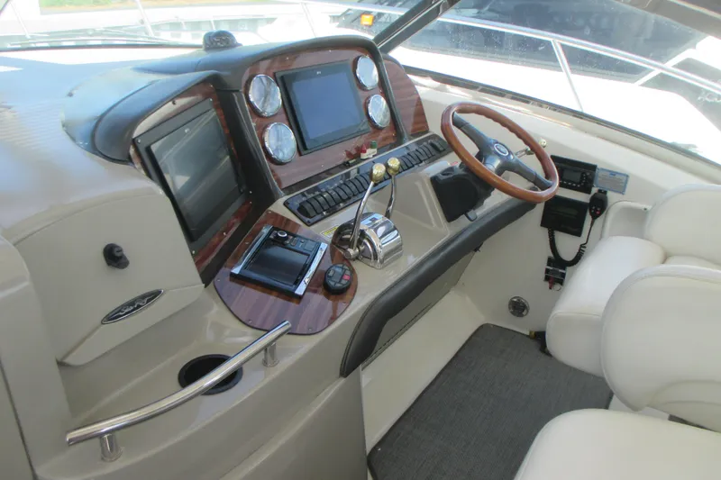 Slide: The Image of Cockpit of 2005 Sea Ray 390 Sundancer with steering wheel and control panels. - 20