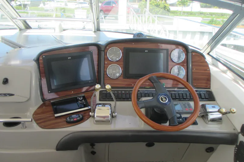 Slide: The Image of Helm of 2005 Sea Ray 390 Sundancer with wood accents and modern controls. - 21