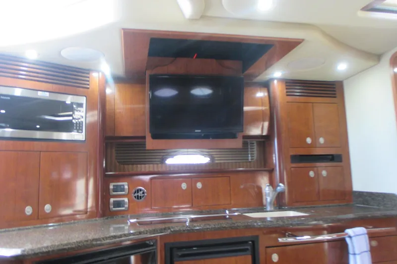 Slide: The Image of Interior of 2005 Sea Ray 390 Sundancer yacht with wood cabinetry and modern appliances. - 25