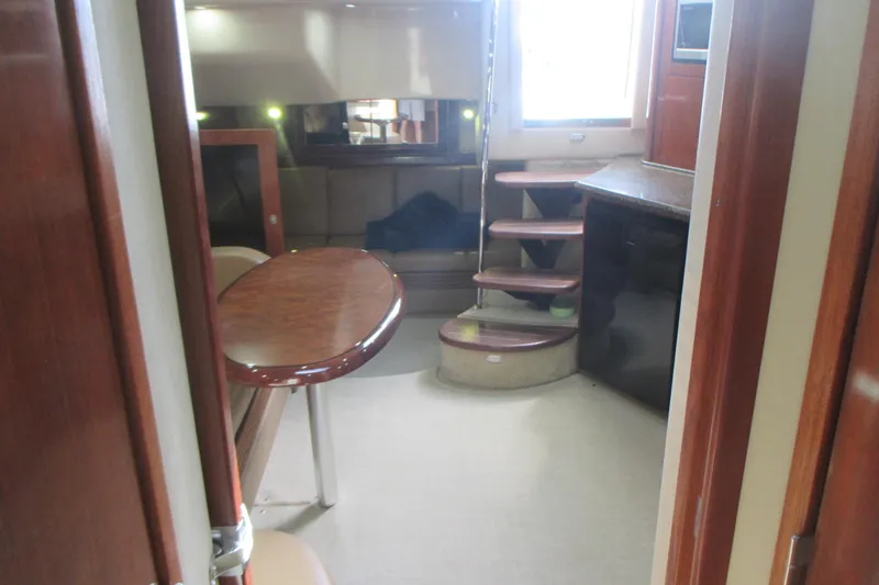 Slide: The Image of Interior of 2005 Sea Ray 390 Sundancer yacht with wooden furnishings and staircase. - 27