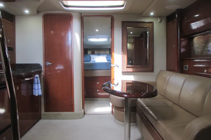 Slide: The Image of Interior of 2005 Sea Ray 390 Sundancer yacht with elegant wood finishes and cozy seating. - 28