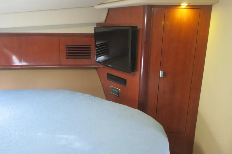 Slide: The Image of Interior of 2005 Sea Ray 390 Sundancer with wood paneling and mounted TV. - 31