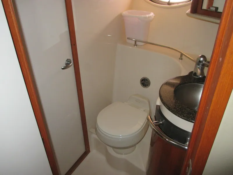 Slide: The Image of Sea Ray 390 Sundancer 2005 bathroom with toilet and sink. - 33