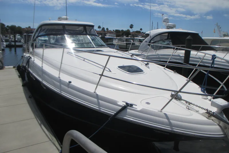 Slide: The Image of 2005 Sea Ray 390 Sundancer yacht docked at marina under clear sky. - 4