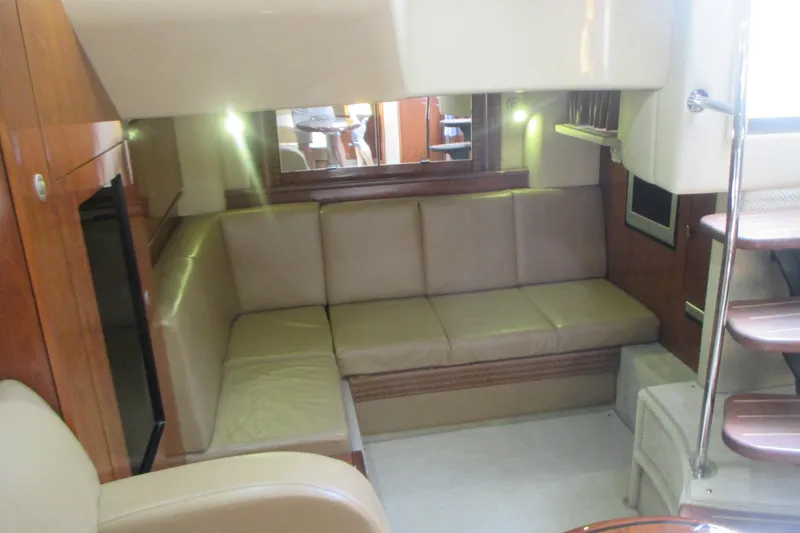 Slide: The Image of Luxurious interior of 2005 Sea Ray 390 Sundancer yacht with beige seating and wooden accents. - 40