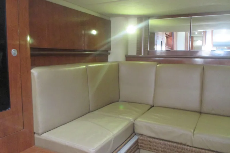Slide: The Image of Interior of 2005 Sea Ray 390 Sundancer with beige leather seating and wooden cabinetry. - 41