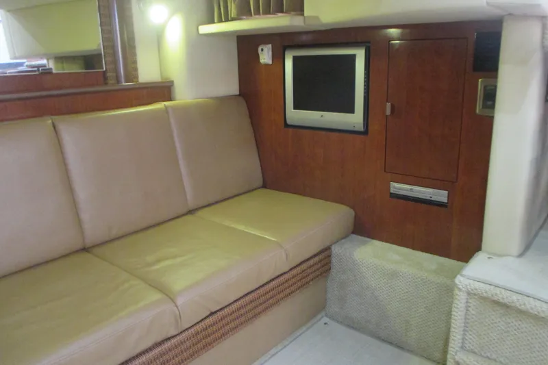 Slide: The Image of Interior of 2005 Sea Ray 390 Sundancer with beige sofa and wall-mounted TV. - 42