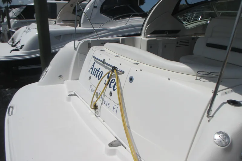 Slide: The Image of 2005 Sea Ray 390 Sundancer yacht docked, featuring spacious seating and sleek design. - 6