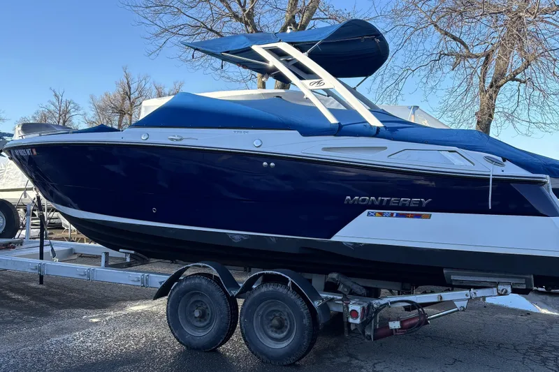 The Image of 2023 Monterey 278SS Super Sport boat on trailer, blue and white design. - 0