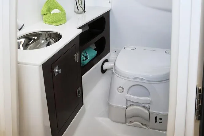 Slide: The Image of Manufacturer Provided Image: 2023 Monterey 278SS Super Sport boat bathroom with sink, storage, and compact toilet. - 12