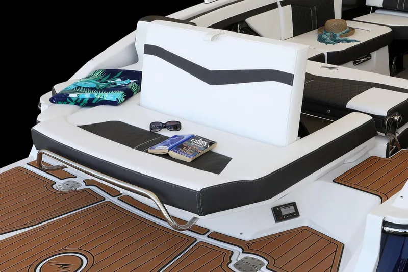 Slide: The Image of Manufacturer Provided Image: 2023 Monterey 278SS Super Sport boat interior with seating, sunglasses, and a book on deck. - 13
