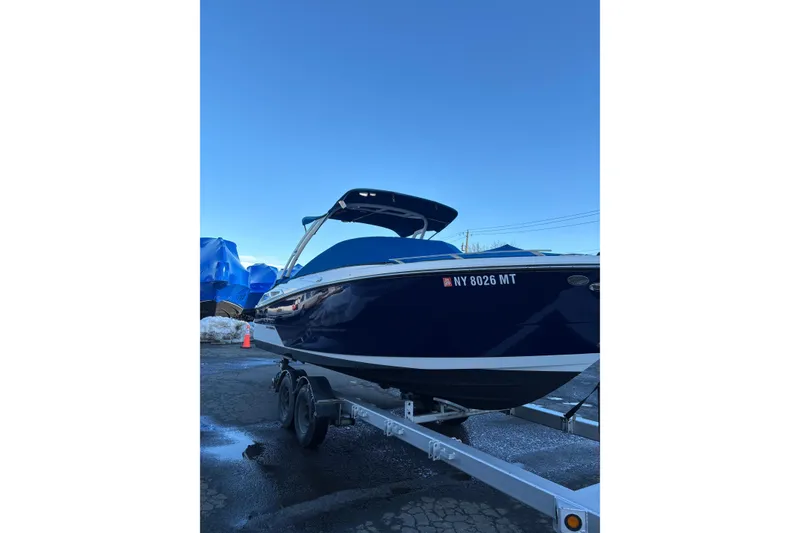 Slide: The Image of 2023 Monterey 278SS Super Sport boat on trailer, blue hull, clear sky background. - 2