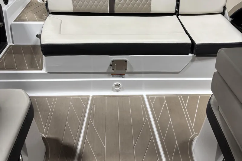 Slide: The Image of 2023 Monterey 278SS Super Sport boat interior with cushioned seating and stylish flooring. - 7