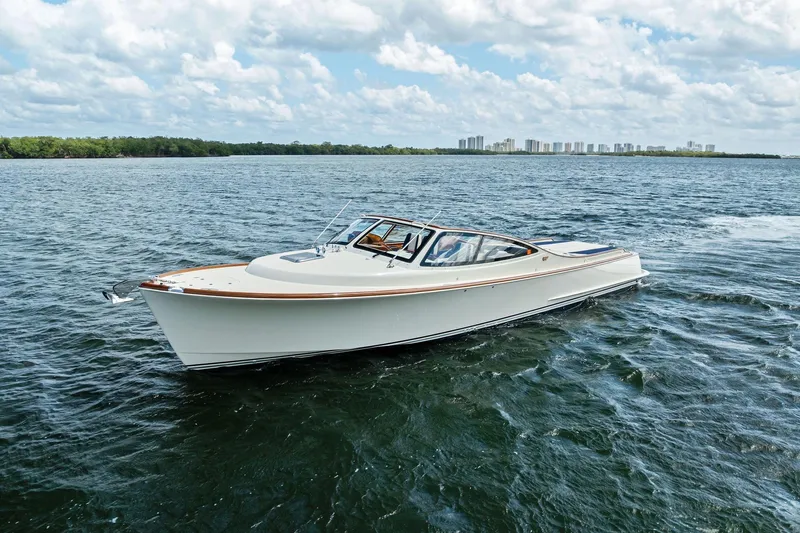 The Image of 2008 Hinckley Talaria 38R cruising on open water under a cloudy sky. - 0