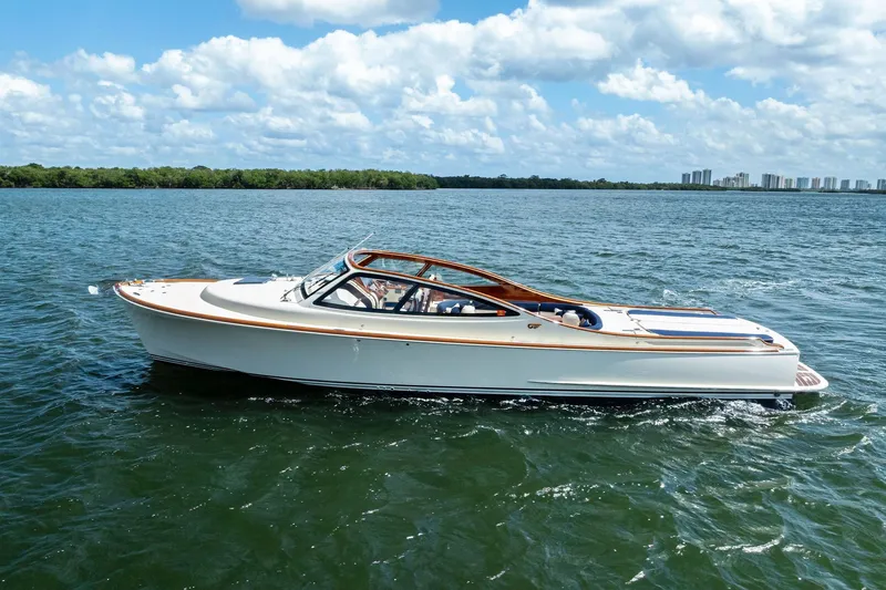 Slide: The Image of 2008 Hinckley Talaria 38R yacht cruising on a sunny day with city skyline in background. - 1