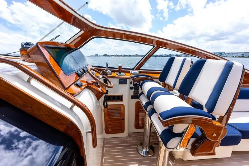 Slide: The Image of Luxurious 2008 Hinckley Talaria 38R yacht cockpit with elegant wood and blue-striped seating. - 13