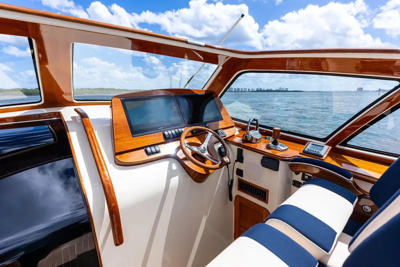 Slide: The Image of Interior view of 2008 Hinckley Talaria 38R yacht cockpit with wooden accents and ocean backdrop. - 14