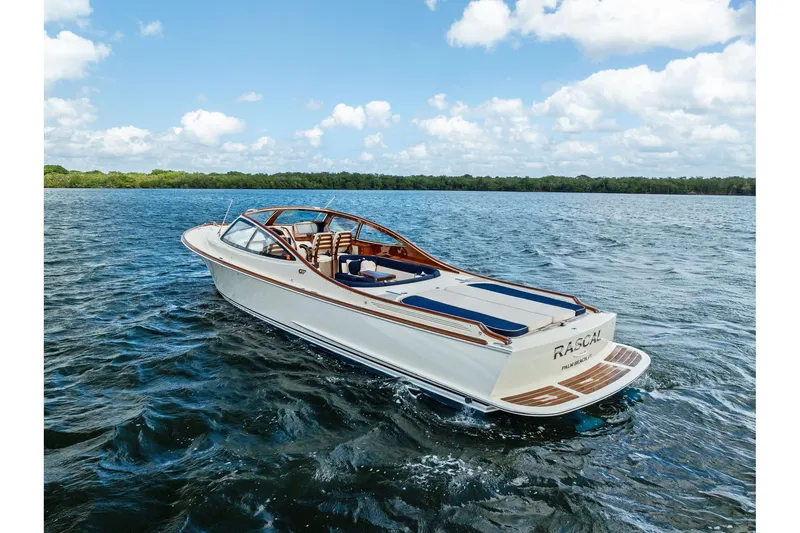 Slide: The Image of 2008 Hinckley Talaria 38R boat cruising on open water under a blue sky. - 3