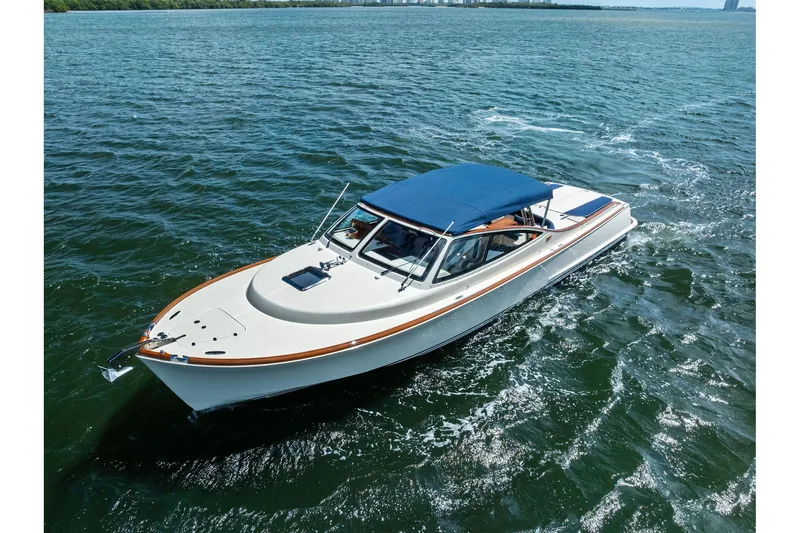 Slide: The Image of 2008 Hinckley Talaria 38R cruising on open water with blue canopy. - 7