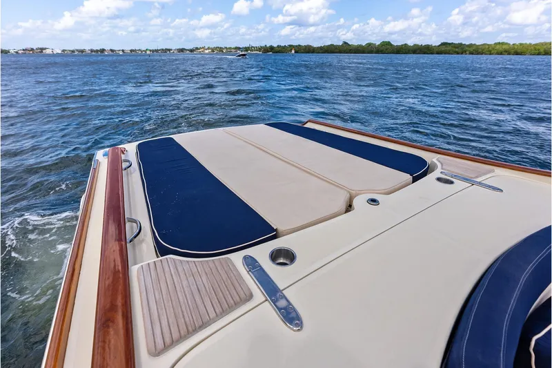 Slide: The Image of 2008 Hinckley Talaria 38R boat deck with cushioned seating on open water. - 8