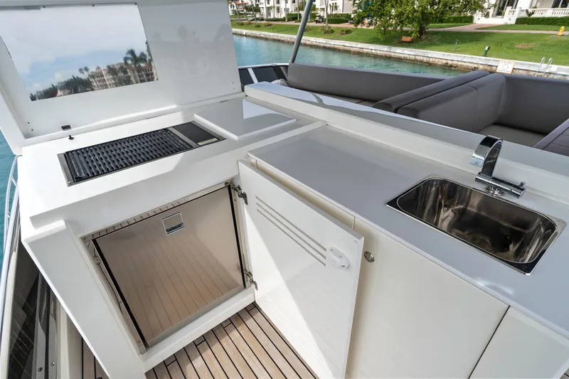 Slide: The Image of Luxurious 2022 Astondoa 66 Flybridge yacht with spacious deck, overlooking city skyline. - 10