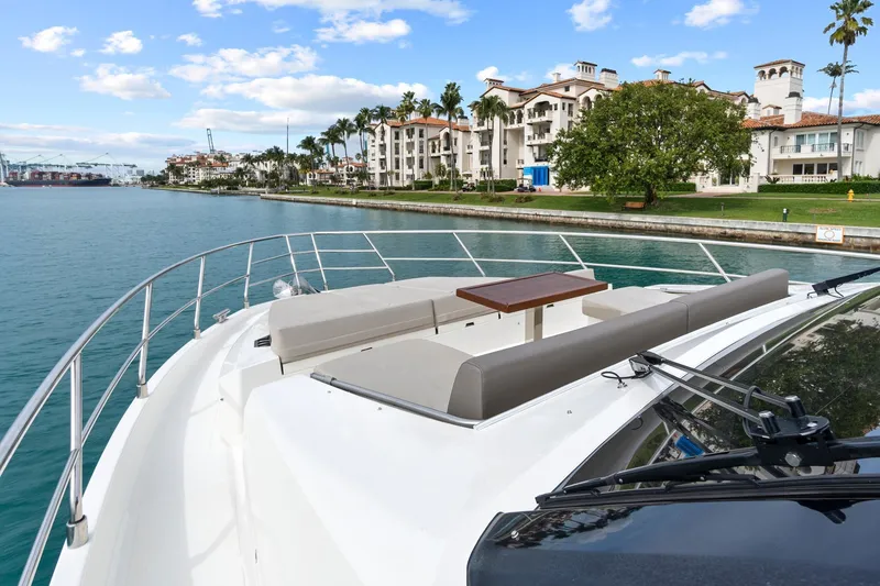 Slide: The Image of Flybridge helm of 2022 Astondoa 66 yacht with city skyline view. - 16