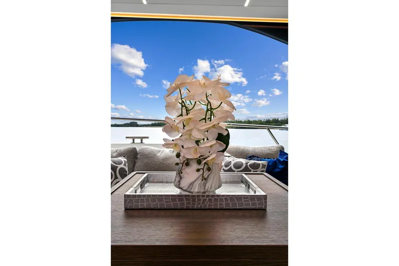 Slide: The Image of Luxurious 2022 Astondoa 66 Flybridge yacht deck with elegant table and scenic ocean view. - 21