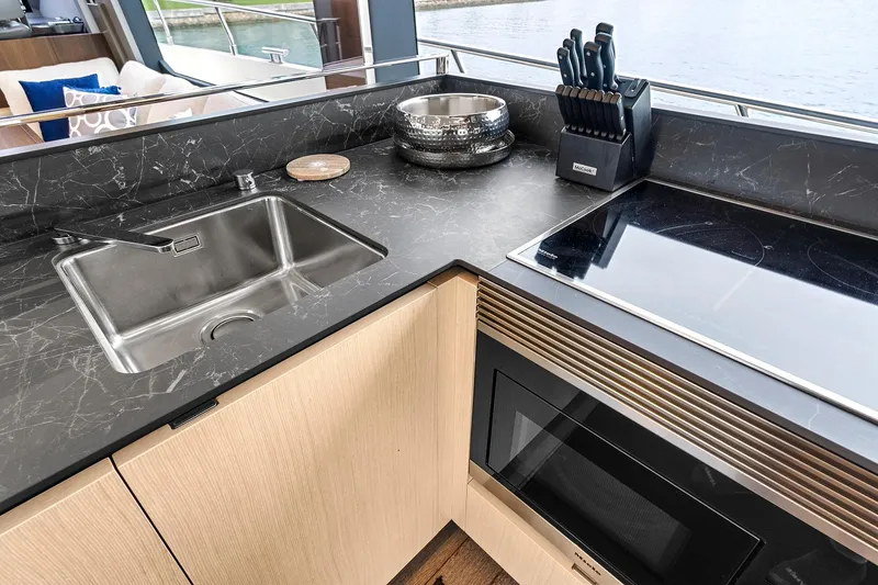 Slide: The Image of Luxurious kitchen interior on 2022 Astondoa 66 Flybridge yacht with modern appliances and sleek design. - 29
