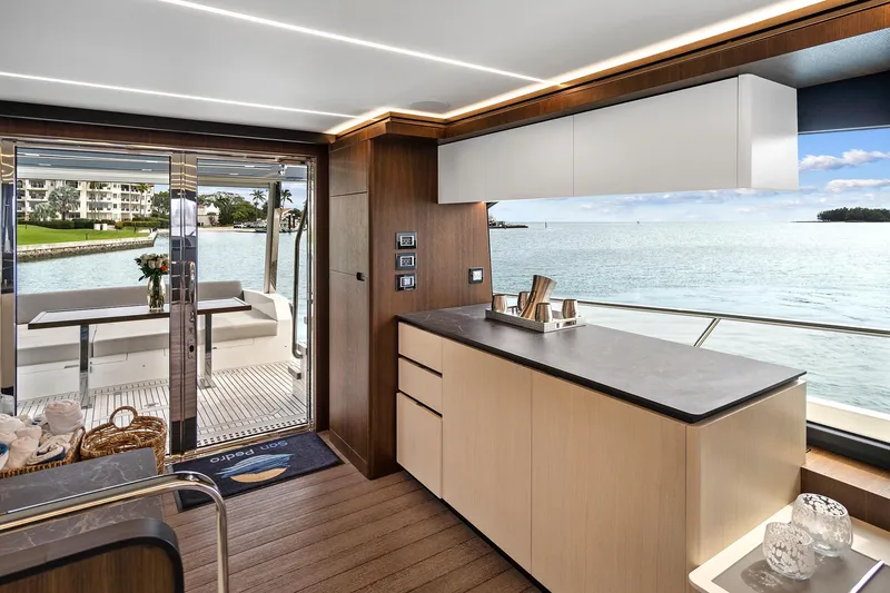 Slide: The Image of Luxurious interior of 2022 Astondoa 66 Flybridge yacht with modern kitchen and outdoor seating. - 32