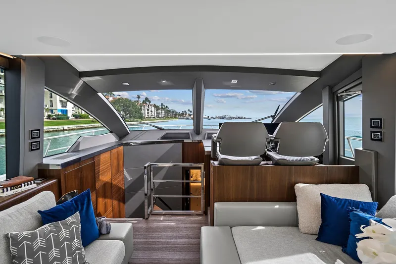 Slide: The Image of Luxurious helm of 2022 Astondoa 66 Flybridge yacht with modern controls and seating. - 35